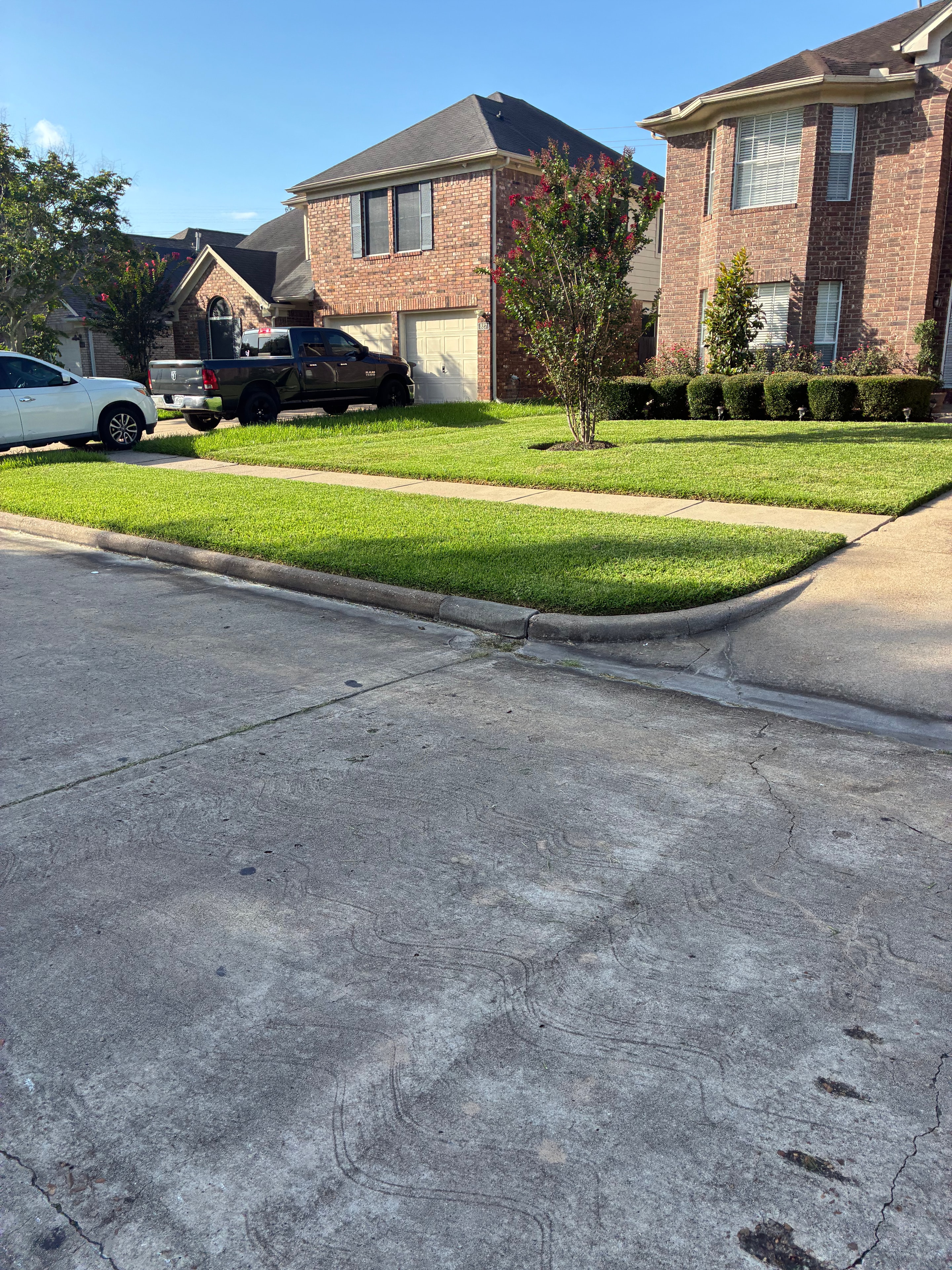 Freshly mowed brick home front yard with crisp curb edging